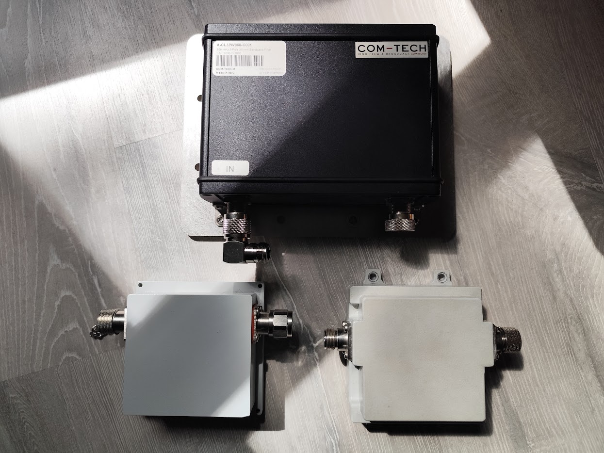 Three 868 MHz bandpass filters: a COM-TECH three-pole cavity filter and two smaller cavity filters