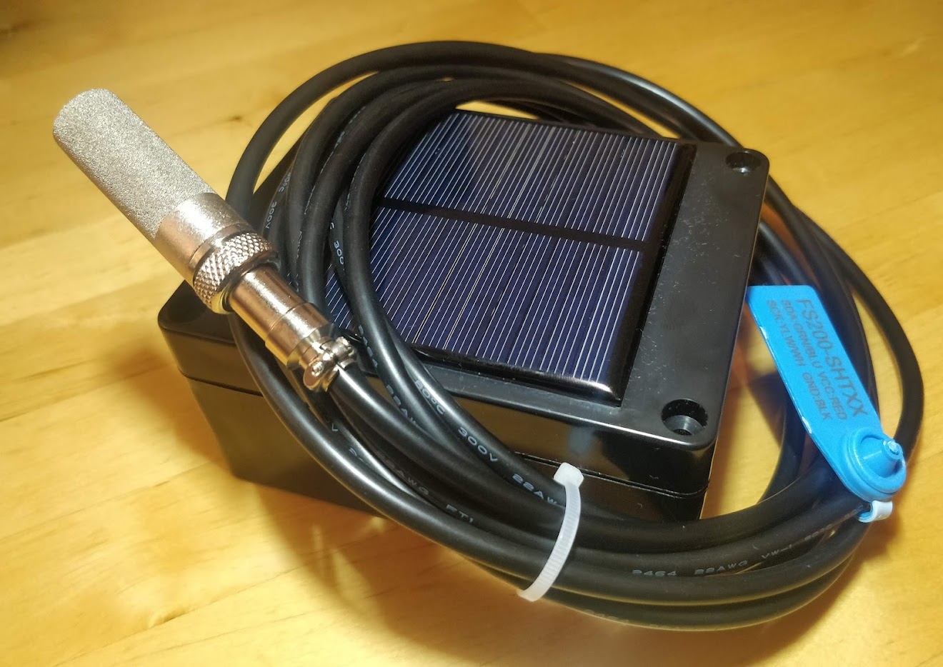 Custom solar-powered LoRaWAN sensor with an SHT temperature and humidity probe in a sintered filter cap