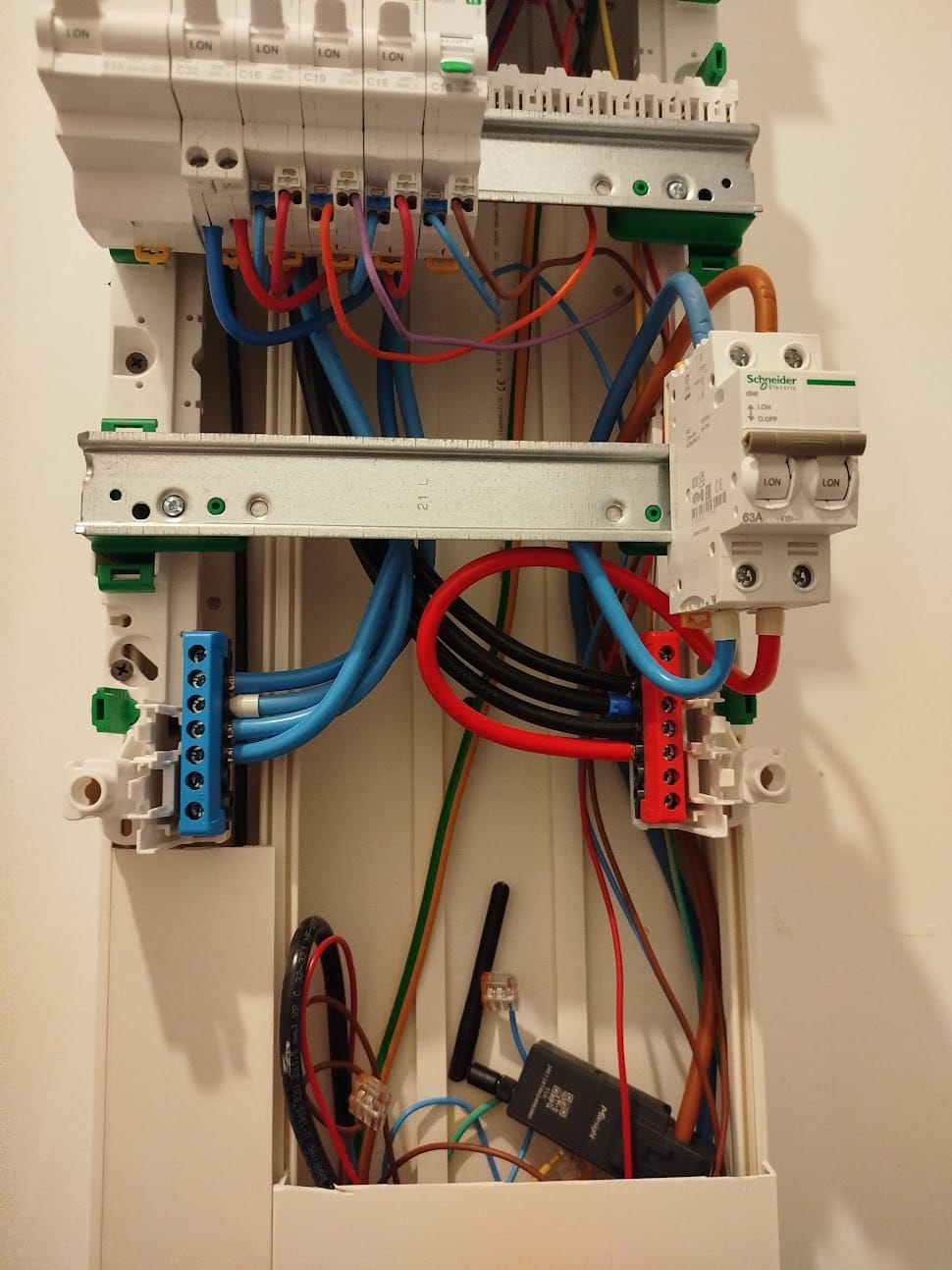 A LoRaWAN sensor installed inside a consumer unit alongside the breakers
