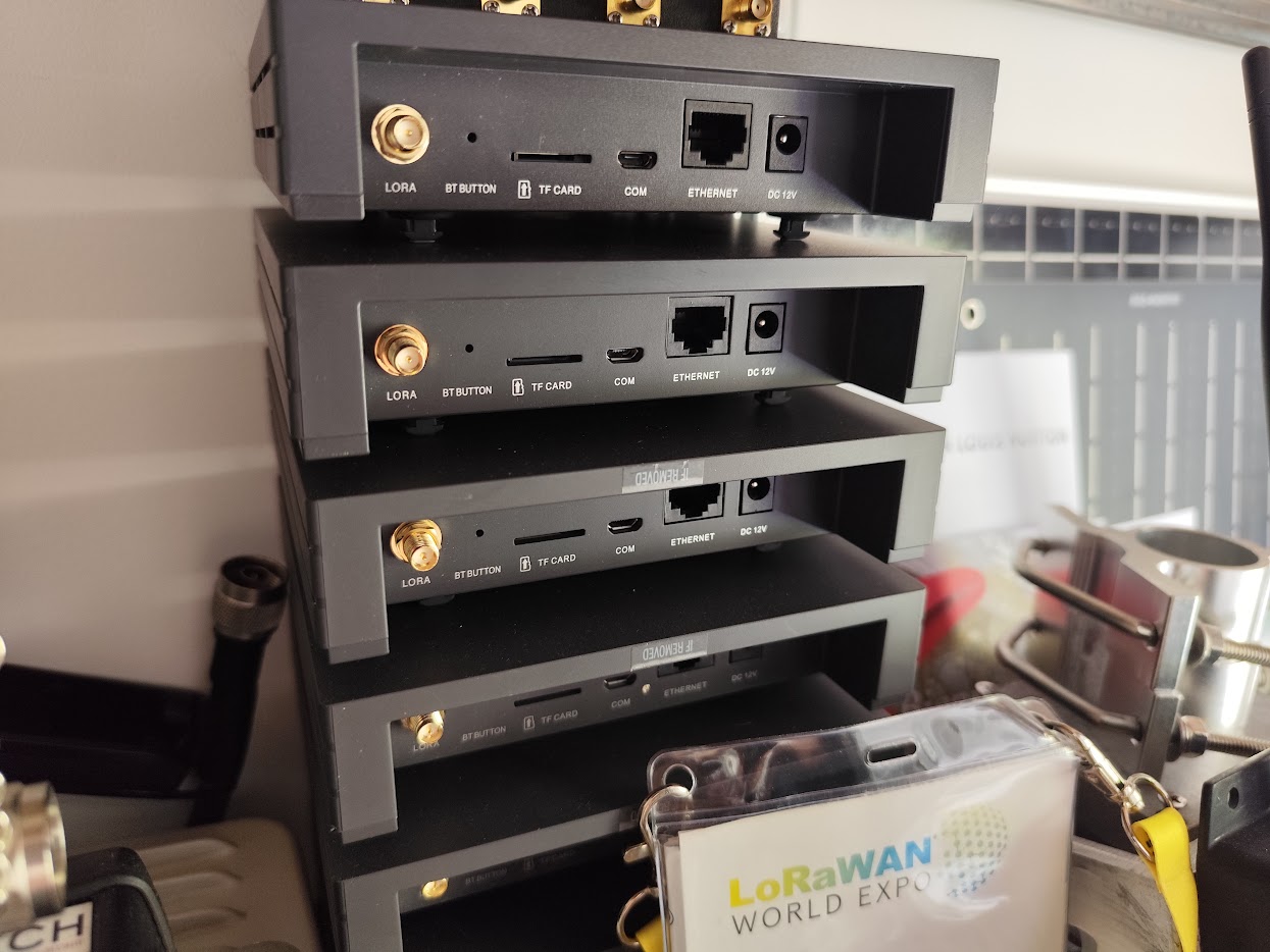 A stack of identical LoRaWAN gateways, each with its LoRa antenna, Ethernet and 12 V connections