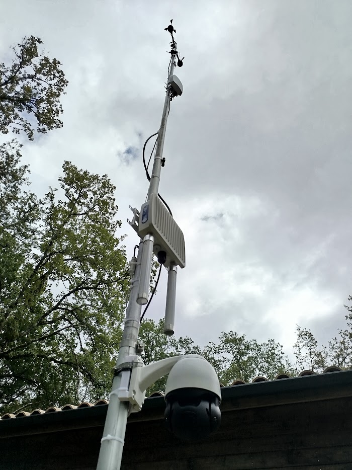 A working pole install: weather sensors, a LoRaWAN gateway and a camera sharing one mast