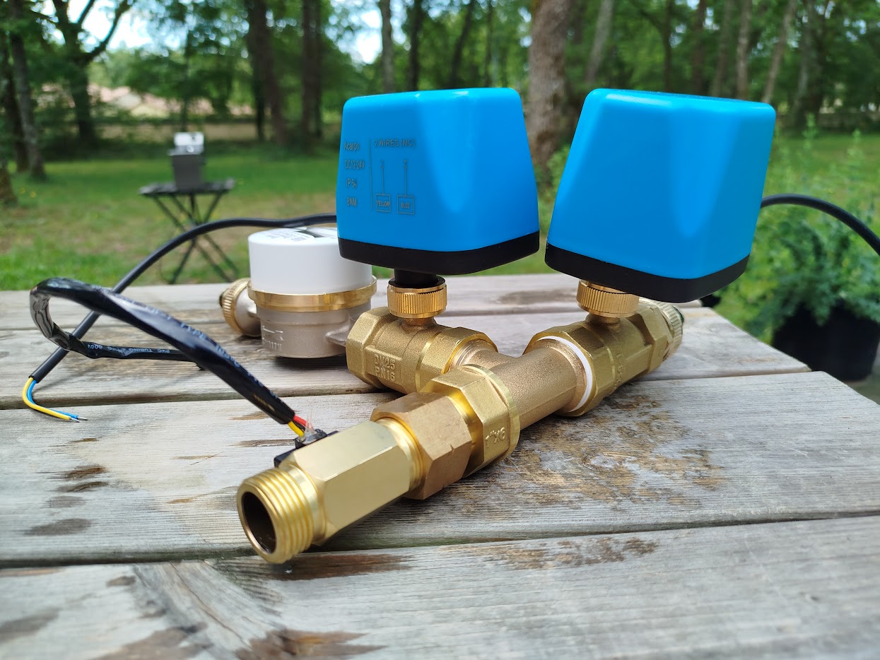 A water meter and motorized ball valves assembled on one manifold
